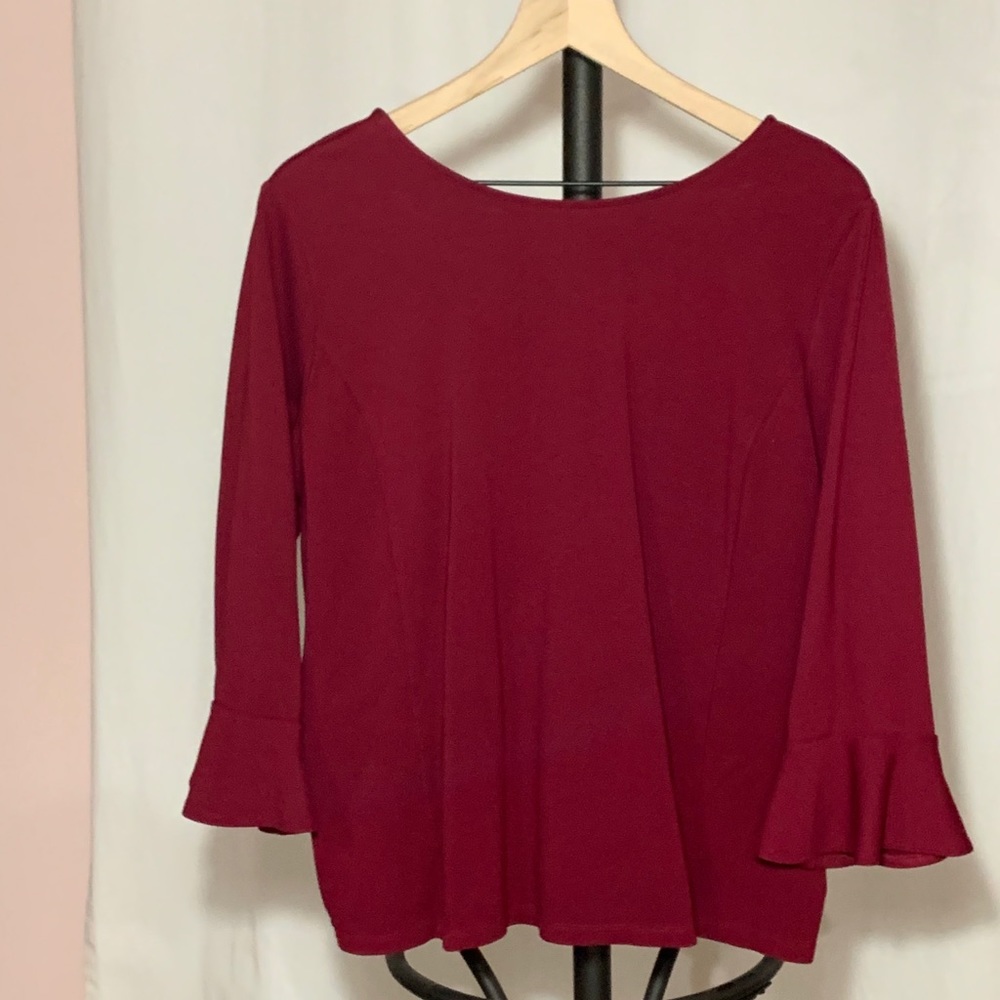 Rich burgundy blouse with 3/4 sleeves.